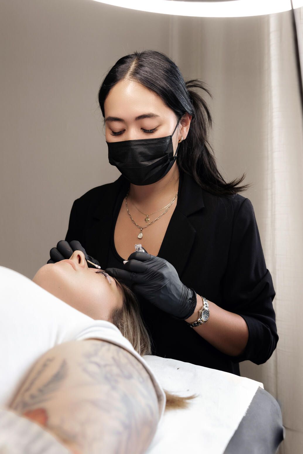 Bebella employee doing lashes extensions and Korean lash lifting.